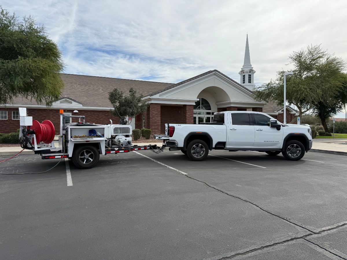 Water Pros hydro jetting truck and trailer at commercial job site