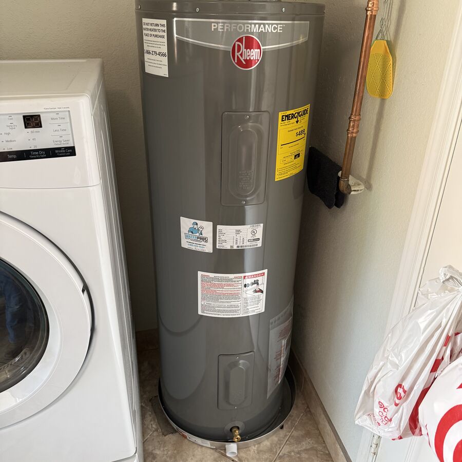 New Rheem Performance 50-gallon electric water heater installed in a laundry room at a Dobson Ranch home in Mesa AZ, with new braided supply lines and ball valve