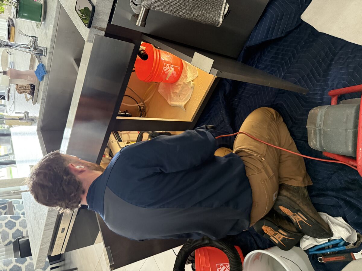 Water Pros Plumbing technician running a hydro-jetter hose through the kitchen sink drain at a Troon home in Scottsdale