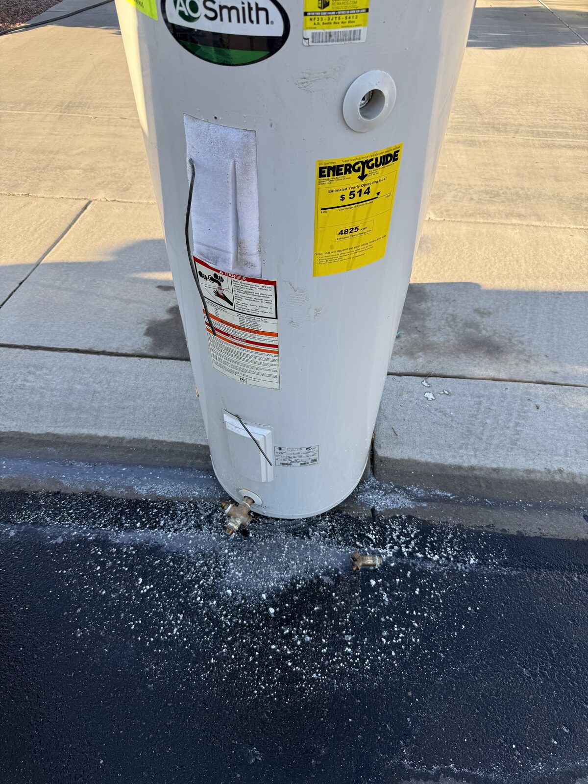 Old leaking water heater with mineral sediment buildup removed by Water Pros Plumbing in Gilbert AZ